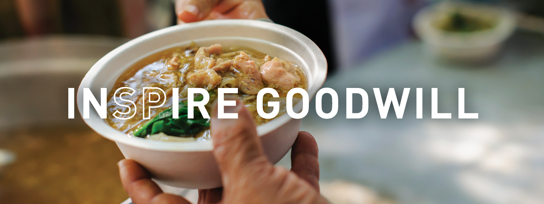 INSPIRE Goodwill INSPIRE Goodwill - person handing someone soup
